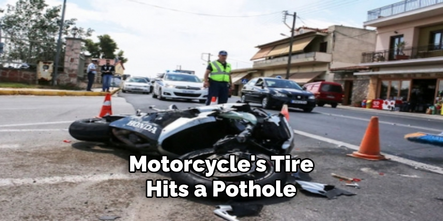 Motorcycle's Tire Hits a Pothole