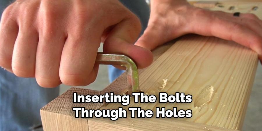 Inserting the Bolts Through the Holes