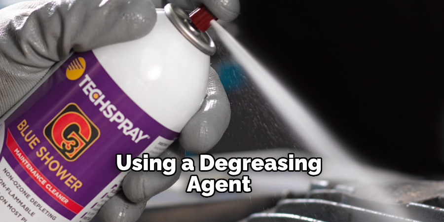 Using a degreasing agent 