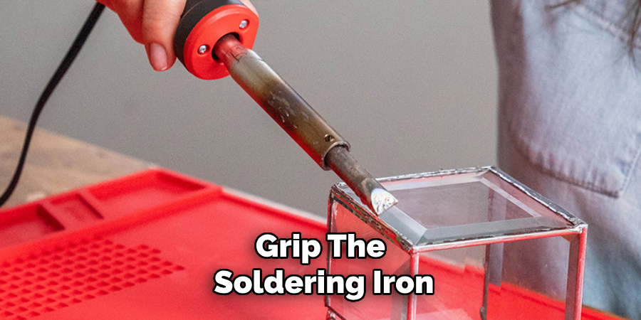 Grip the soldering iron