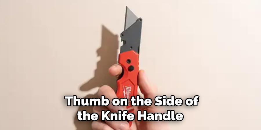 Thumb on the Side of the Knife Handle 