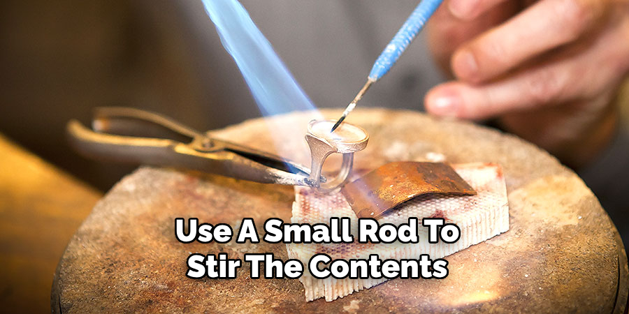 Use A Small Rod To
Stir The Contents